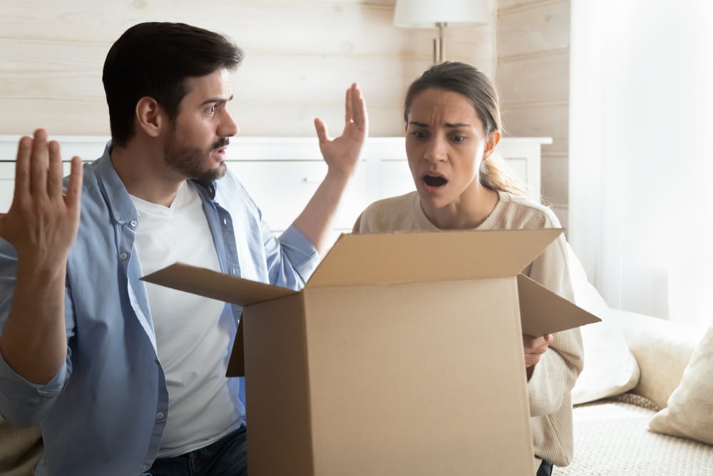 Photo of Shocked Couple Opening Box