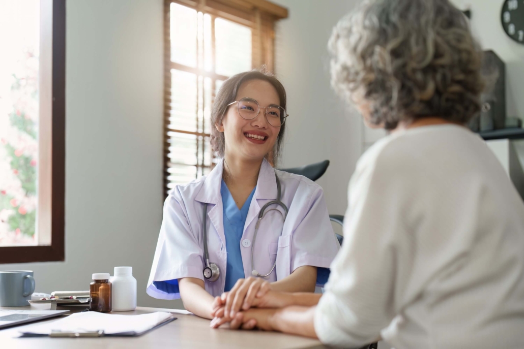 Doctor talking to Asian elderly woman
