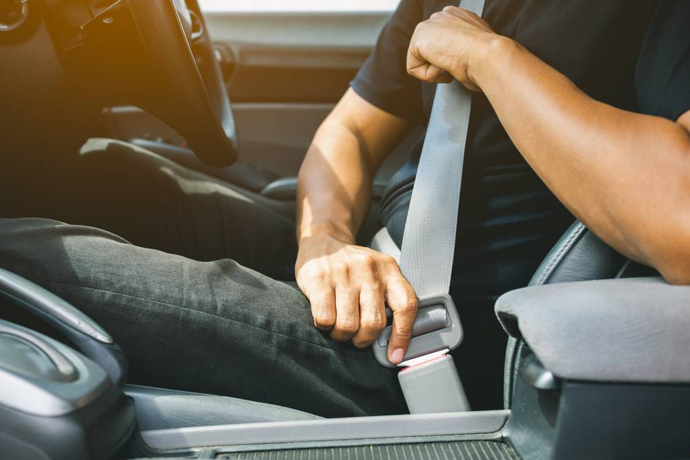Photo of man buckling seatbelt