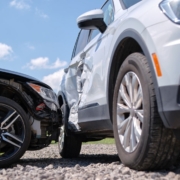 Car accident involving a white SUV and a black sedan