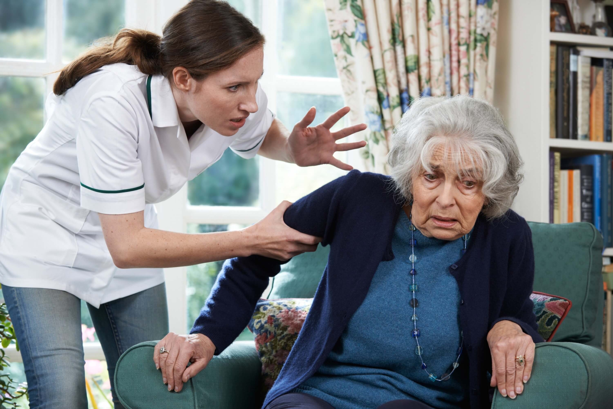 Care worker mistreating elderly woman at home