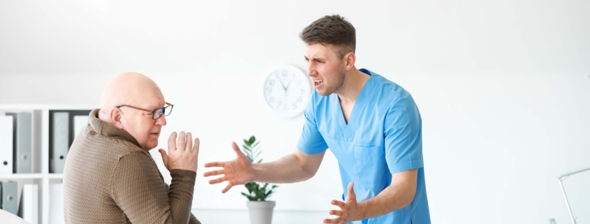 Medical worker mistreating an elderly man in a nursing home